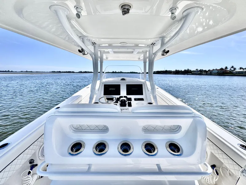 Slide: The Image of 2017 Intrepid 375 FE boat interior with helm, ocean view, and clear sky. - 2