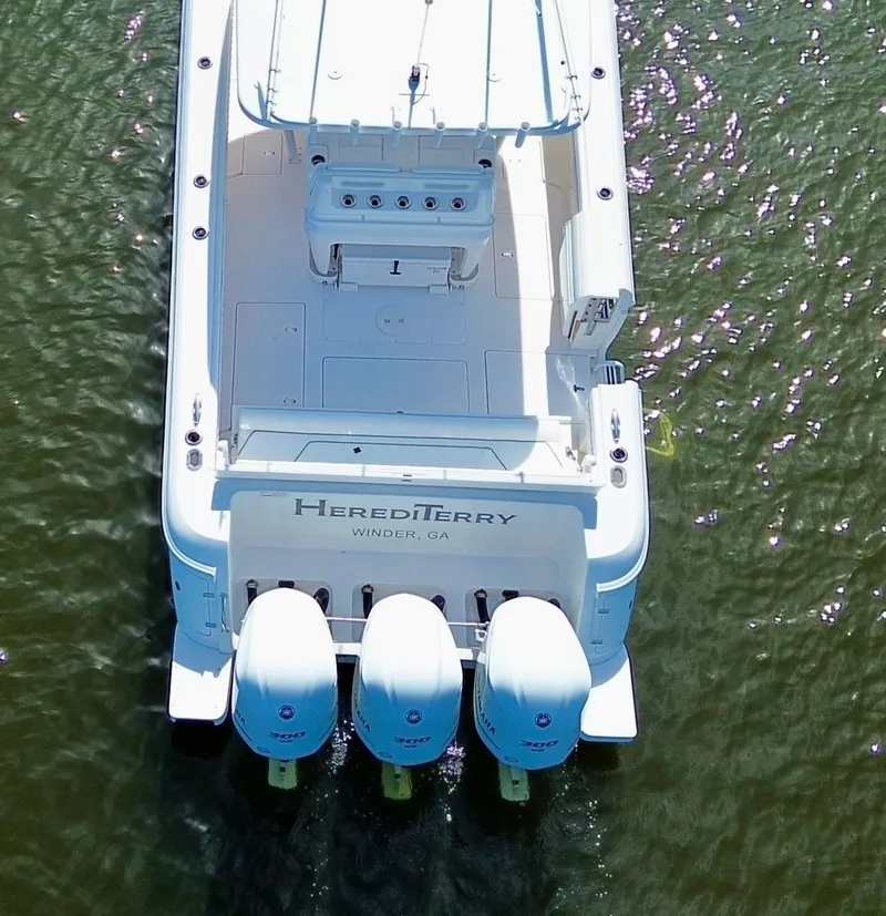 Slide: The Image of Aerial view of 2017 Intrepid 375 FE boat with triple engines on water. - 20