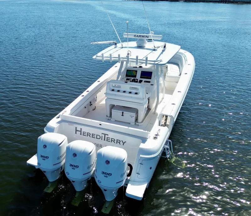 Slide: The Image of 2017 Intrepid 375 FE boat with triple Yamaha engines on calm water. - 23