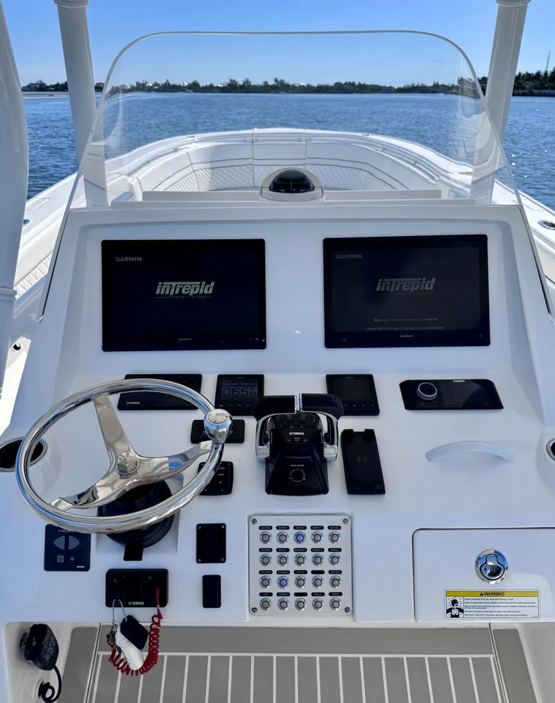 Slide: The Image of 2017 Intrepid 375 FE boat dashboard with dual Garmin displays and steering wheel. - 3