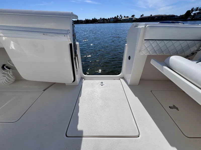 Slide: The Image of 2017 Intrepid 375 FE boat deck with open door, overlooking calm water. - 8