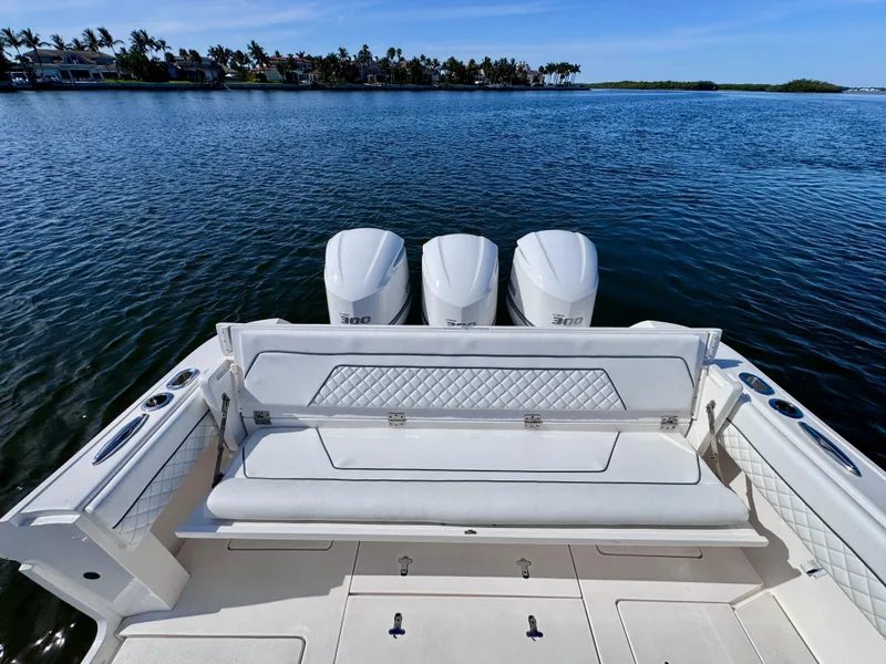 Slide: The Image of 2017 Intrepid 375 FE boat with triple engines on calm water. - 9