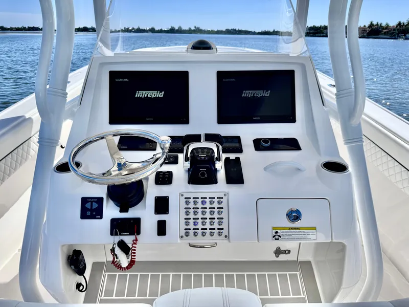 Slide: The Image of 2017 Intrepid 375 FE boat dashboard with dual Garmin displays and steering wheel. - 17