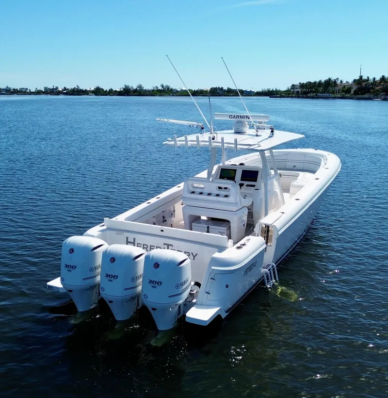 Slide: The Image of 2017 Intrepid 375 FE boat with triple Yamaha engines on calm water. - 24