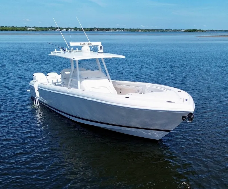 Slide: The Image of 2017 Intrepid 375 FE boat on calm water, featuring sleek design and advanced navigation equipment. - 26