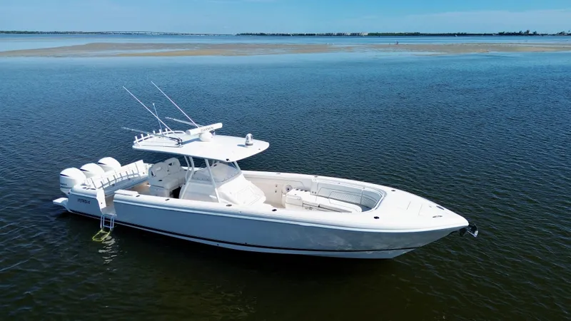 Slide: The Image of 2017 Intrepid 375 FE boat on calm water, showcasing sleek design and triple engines. - 29