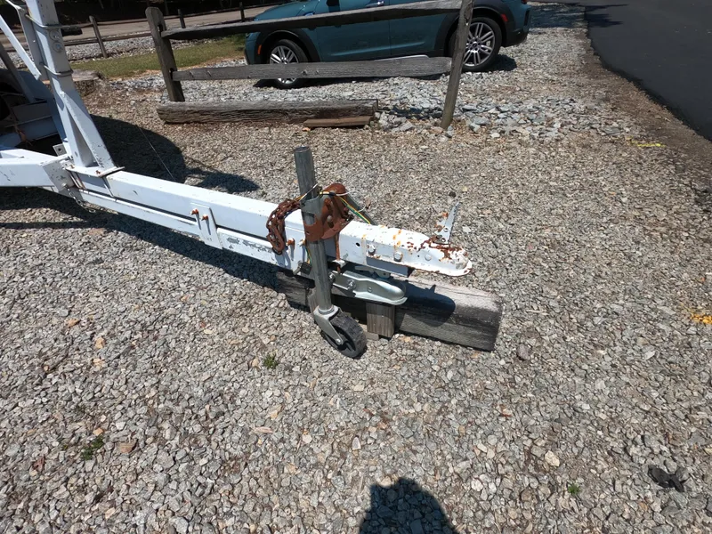 Slide: The Image of Trailer hitch of a 1980 Com-Pac 23 sailboat on gravel surface. - 4