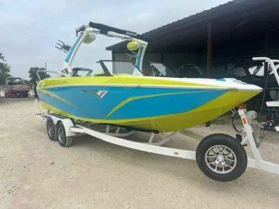 Slide: The Image of 2024 Tigé Z3 boat in vibrant blue and green on a trailer. - 3