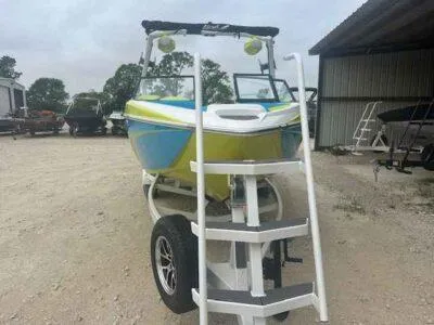 Slide: The Image of 2024 Tigé Z3 boat on trailer with ladder, parked outdoors near a shed. - 4