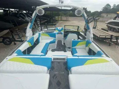 Slide: The Image of 2024 Tigé Z3 boat interior with blue and green accents, spacious seating, and modern design. - 8