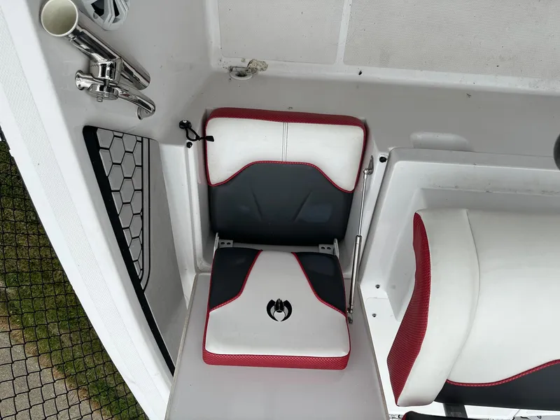Slide: The Image of 2018 Scarab 195 Open ID boat interior with red and white seating and stainless steel fixtures. - 3