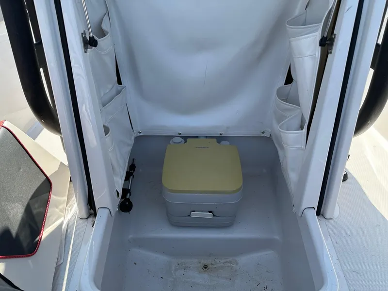 Slide: The Image of Portable toilet inside 2018 Scarab 195 Open ID boat compartment. - 8