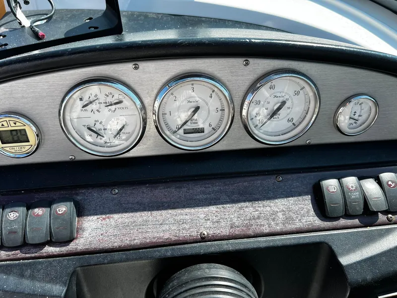 Slide: The Image of Dashboard of a 2008 Regal 2200 Bowrider boat with gauges and controls. - 11