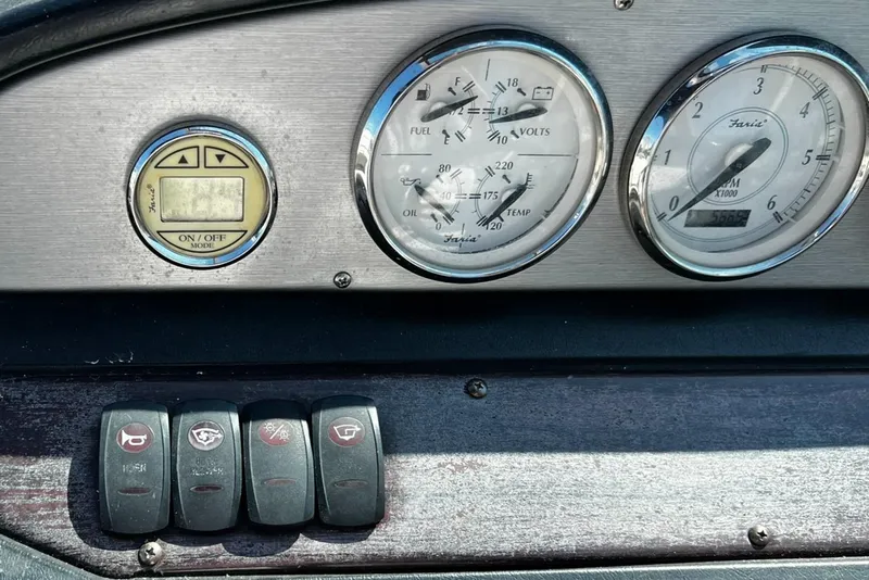 Slide: The Image of Dashboard of a 2008 Regal 2200 Bowrider with gauges and control switches. - 12
