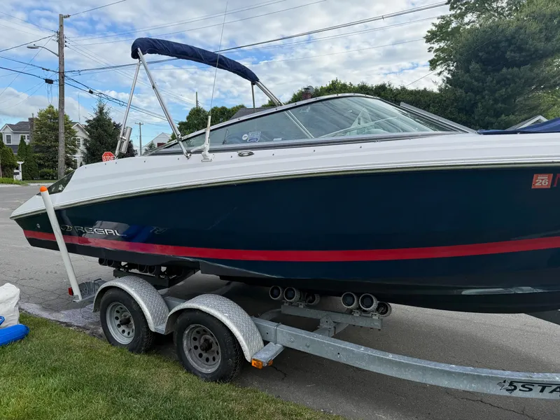 Slide: The Image of 2008 Regal 2200 Bowrider boat on trailer, parked on a suburban street. - 20