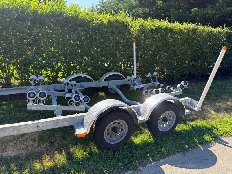 Slide: The Image of Boat trailer for 2008 Regal 2200 Bowrider, parked on grass near hedges. - 21