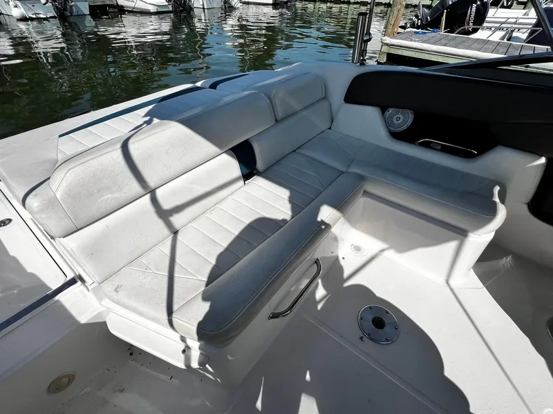 Slide: The Image of 2008 Regal 2200 Bowrider interior with white seating, docked by the water. - 6