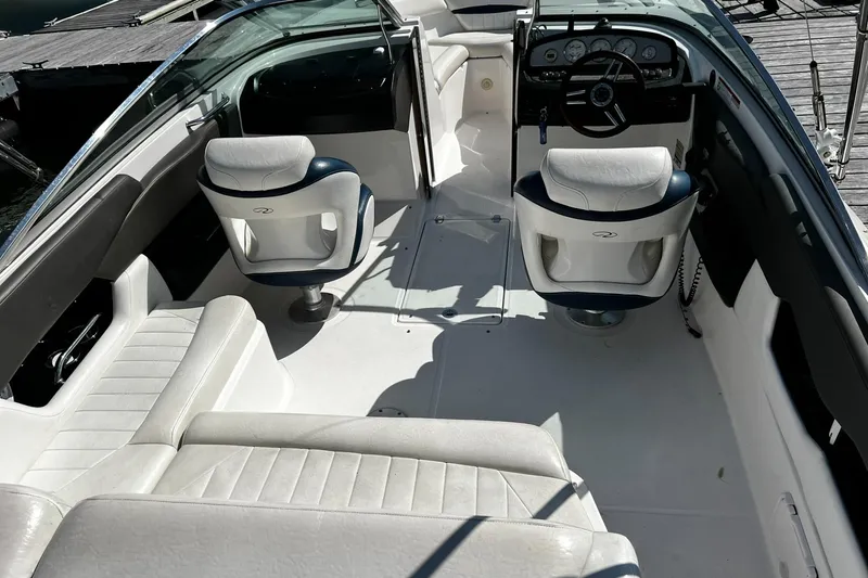 Slide: The Image of 2008 Regal 2200 Bowrider interior with white seating and dashboard view. - 8