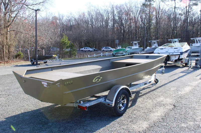 Slide: The Image of 2025 G3 Gator Tough 1860 VBW boat on trailer in outdoor setting. - 4