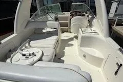 Slide: The Image of 2003 Sea Ray 260 Sundancer boat interior with seating and helm. - 2