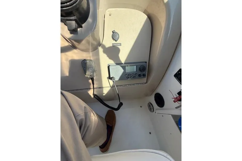Slide: The Image of 2003 Sea Ray 260 Sundancer boat dashboard with radio and control panel. - 9