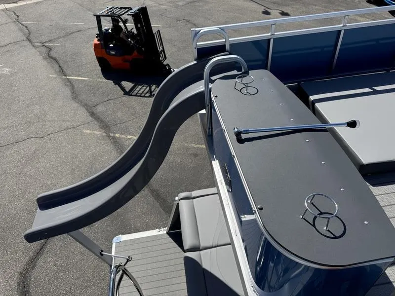 Slide: The Image of 2025 Avalon 2585 27 Catalina CRFS boat with slide and forklift in background. - 11