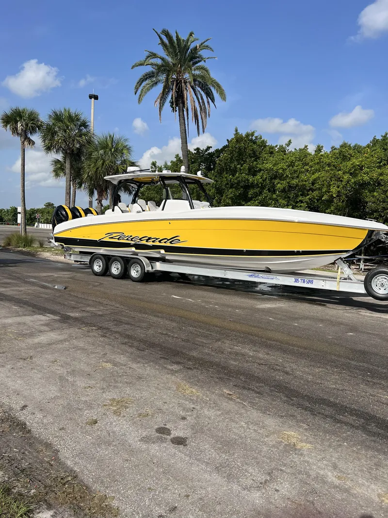 The Image of 2023 Renegade 38' Open boat on trailer, yellow and white, palm trees in background. - 0