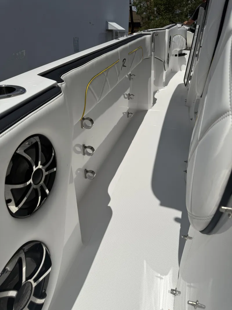Slide: The Image of 2023 Renegade 38' Open boat interior with speakers and sleek white design. - 11