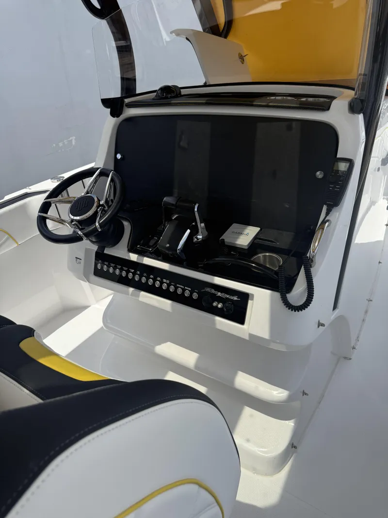Slide: The Image of 2023 Renegade 38' Open boat cockpit with steering wheel and control panel. - 12
