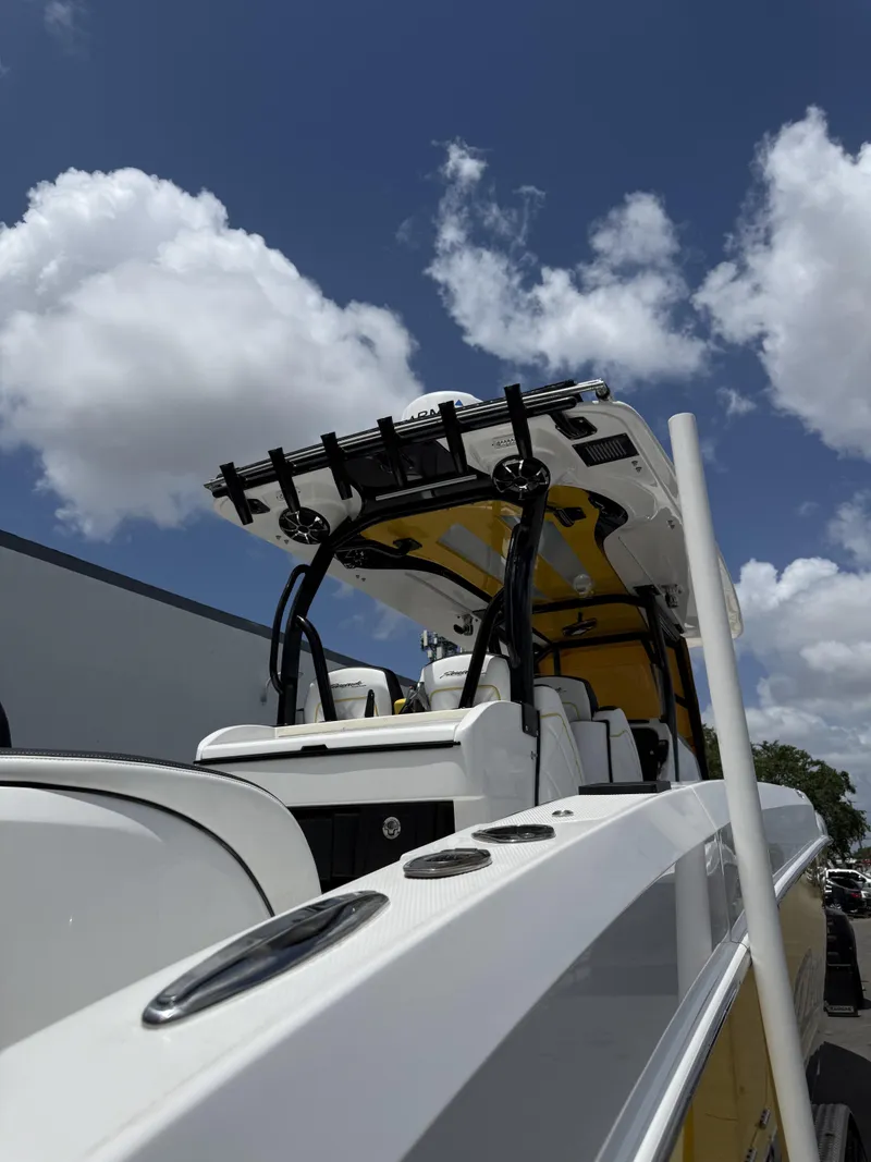 Slide: The Image of 2023 Renegade 38' Open boat with sleek design under a clear blue sky. - 17