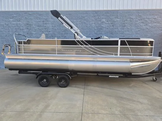 The Image of 2026 South Bay 224FCR LE pontoon boat on trailer, parked outdoors. - 1