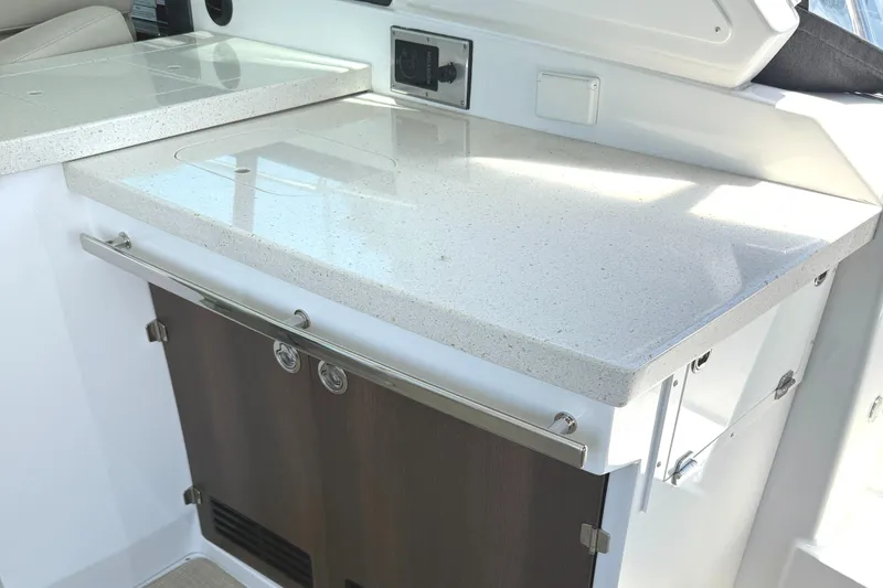 Slide: The Image of 2016 Monterey 360 Sport Coupe interior with sleek countertop and storage cabinets. - 17