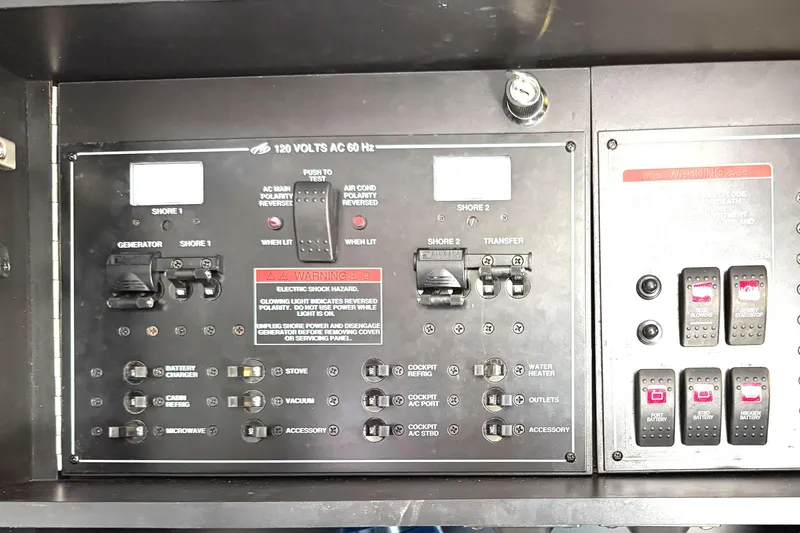 Slide: The Image of Control panel of a 2016 Monterey 360 Sport Coupe, featuring various switches and warning labels. - 25