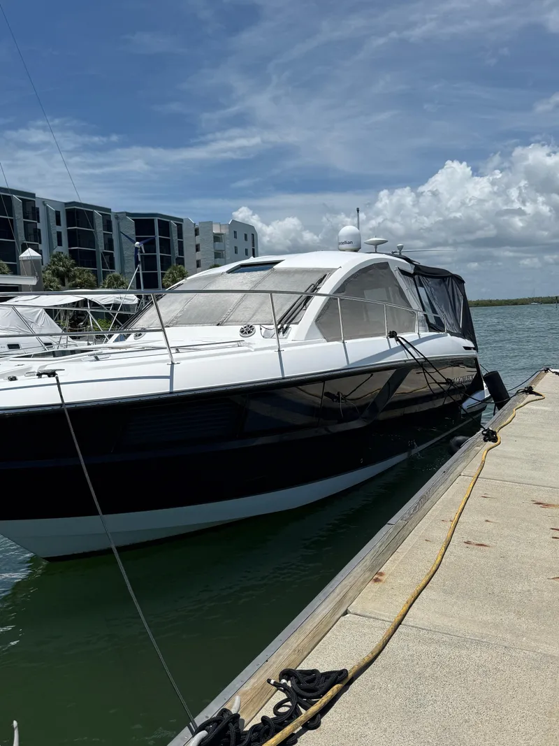 Slide: The Image of 2016 Monterey 360 Sport Coupe docked by waterfront buildings under a clear sky. - 4