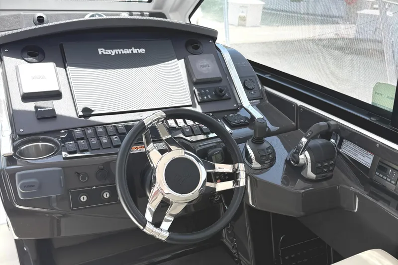 Slide: The Image of 2016 Monterey 360 Sport Coupe helm with Raymarine navigation system and modern controls. - 7