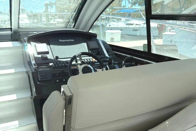 Slide: The Image of 2016 Monterey 360 Sport Coupe helm with Raymarine navigation system, docked at marina. - 8