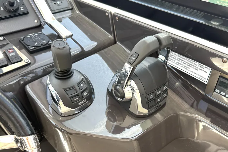 Slide: The Image of Control panel of a 2016 Monterey 360 Sport Coupe boat with joystick and throttle. - 9