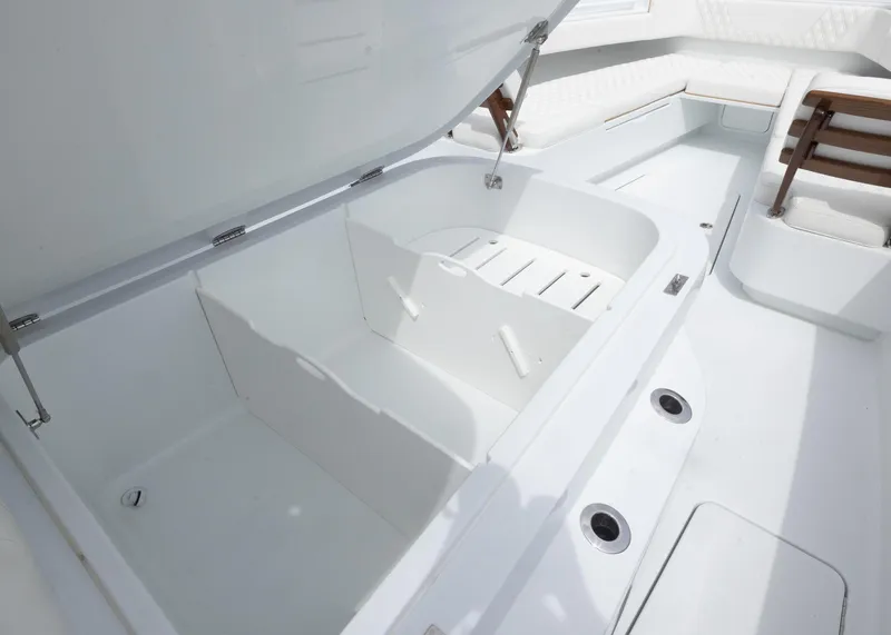 Slide: The Image of 2025 Invincible 43 Open Fisherman boat interior with open storage compartment. - 11