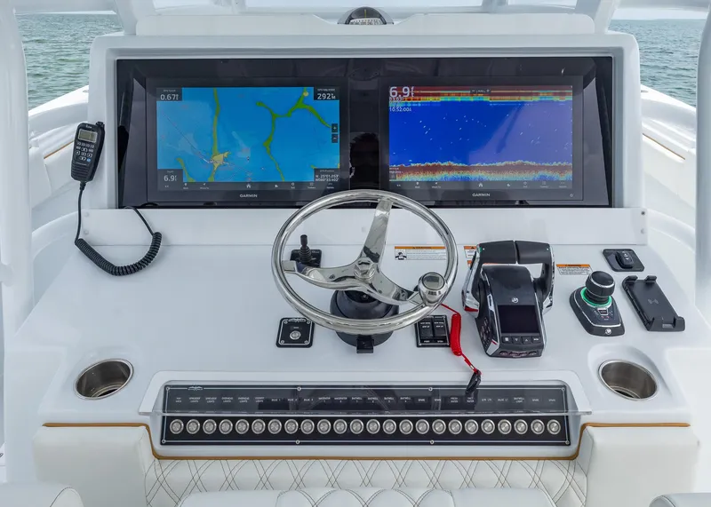 Slide: The Image of 2025 Invincible 43 Open Fisherman dashboard with dual Garmin displays and modern controls. - 15