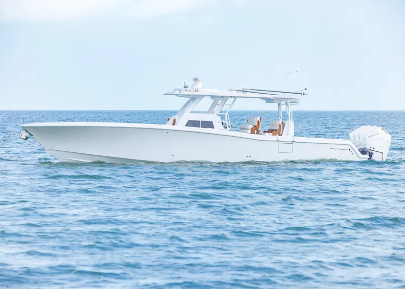 Slide: The Image of 2025 Invincible 43 Open Fisherman boat on calm ocean waters. - 2