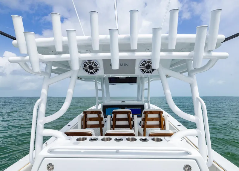 Slide: The Image of 2025 Invincible 43 Open Fisherman boat with rod holders and seating, on open water. - 22