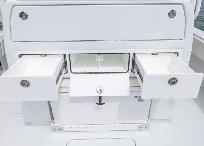 Slide: The Image of 2025 Invincible 43 Open Fisherman boat storage compartments with open drawers. - 25