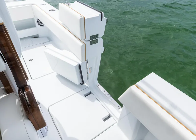 Slide: The Image of 2025 Invincible 43 Open Fisherman boat, white deck, near water, featuring sleek seating and modern design. - 26