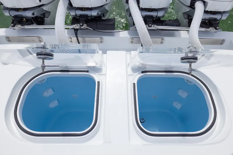 Slide: The Image of Livewell compartments on 2025 Invincible 43 Open Fisherman boat, featuring dual outboard engines. - 29