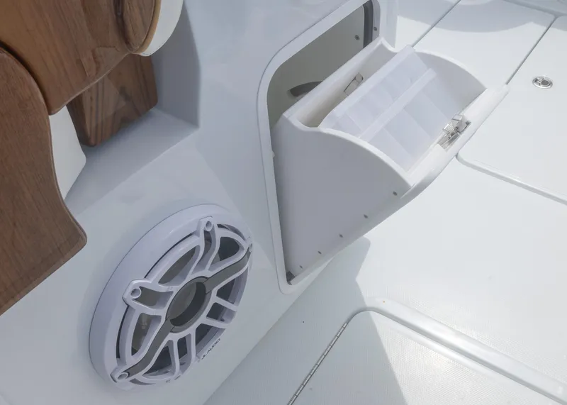Slide: The Image of 2025 Invincible 43 Open Fisherman boat with storage compartment and speaker detail. - 40