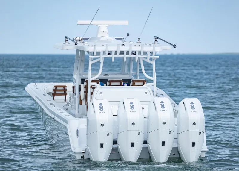 Slide: The Image of 2025 Invincible 43 Open Fisherman boat with four powerful outboard engines on the ocean. - 46