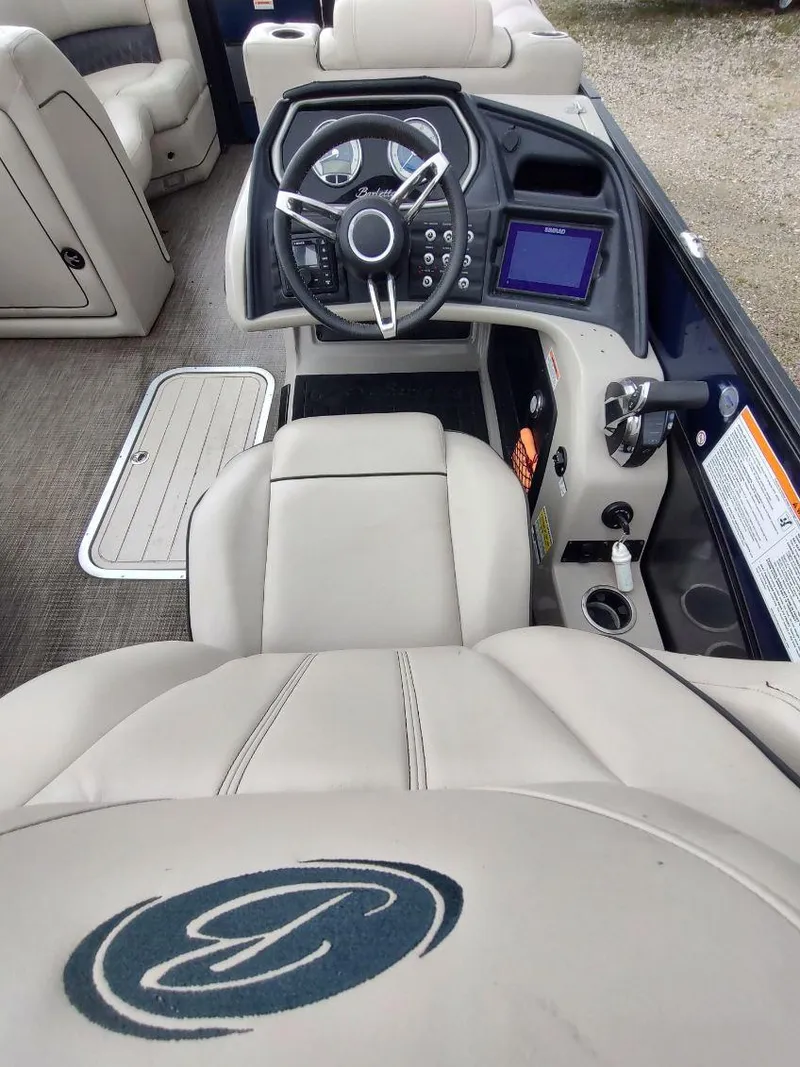 Slide: The Image of 2020 Barletta L23QC boat interior with steering wheel and control panel. - 14