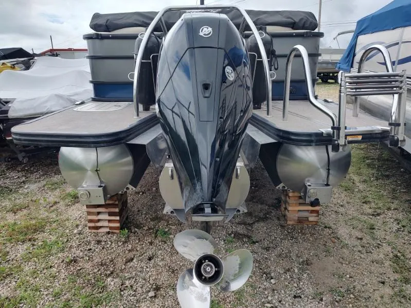 Slide: The Image of 2020 Barletta L23QC pontoon boat with outboard motor, parked on gravel. - 15