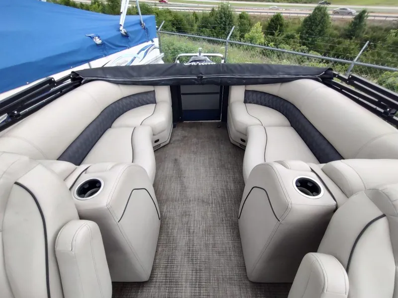 Slide: The Image of Luxurious seating on a 2020 Barletta L23QC pontoon boat, featuring plush upholstery and cup holders. - 16