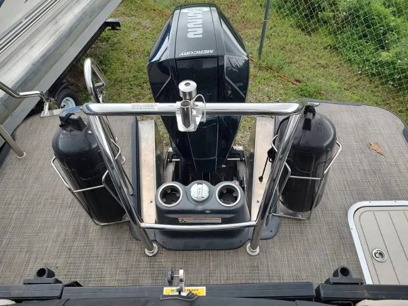 Slide: The Image of 2020 Barletta L23QC boat with Mercury engine and dual fenders on deck. - 9